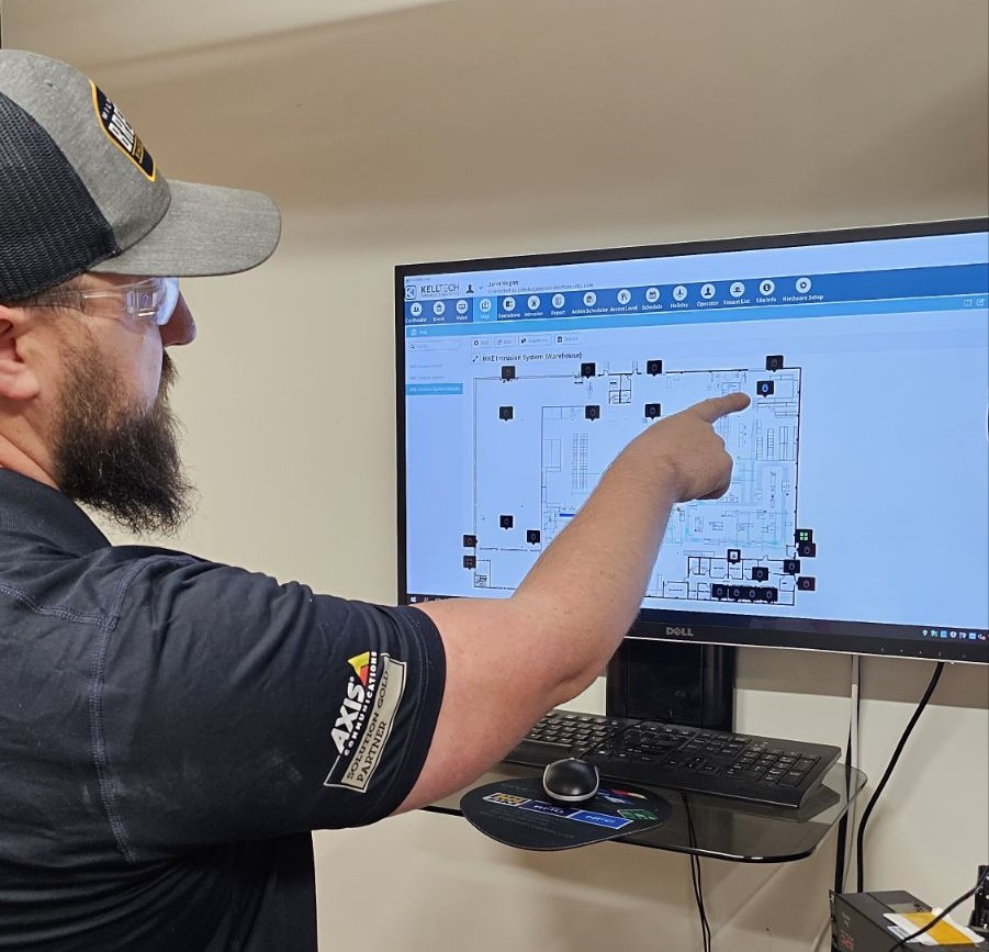 An AdvaTech technician pointing out devices on a facility floor plan