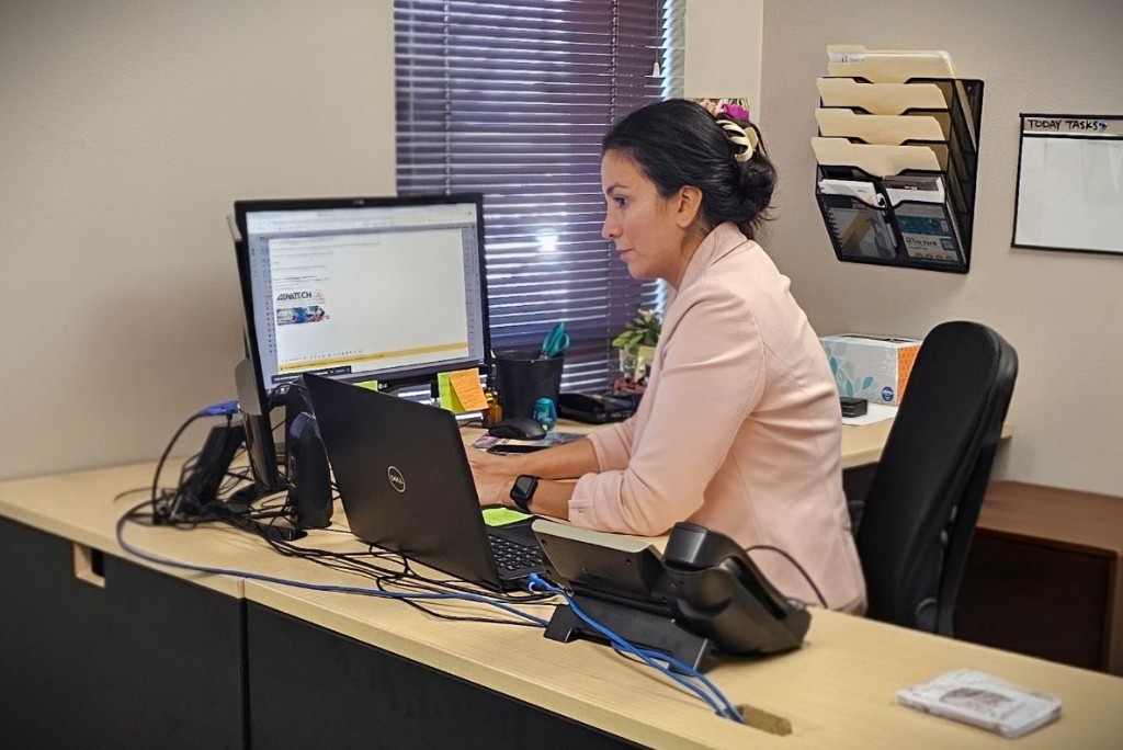 An AdvaTech team member working at her desk