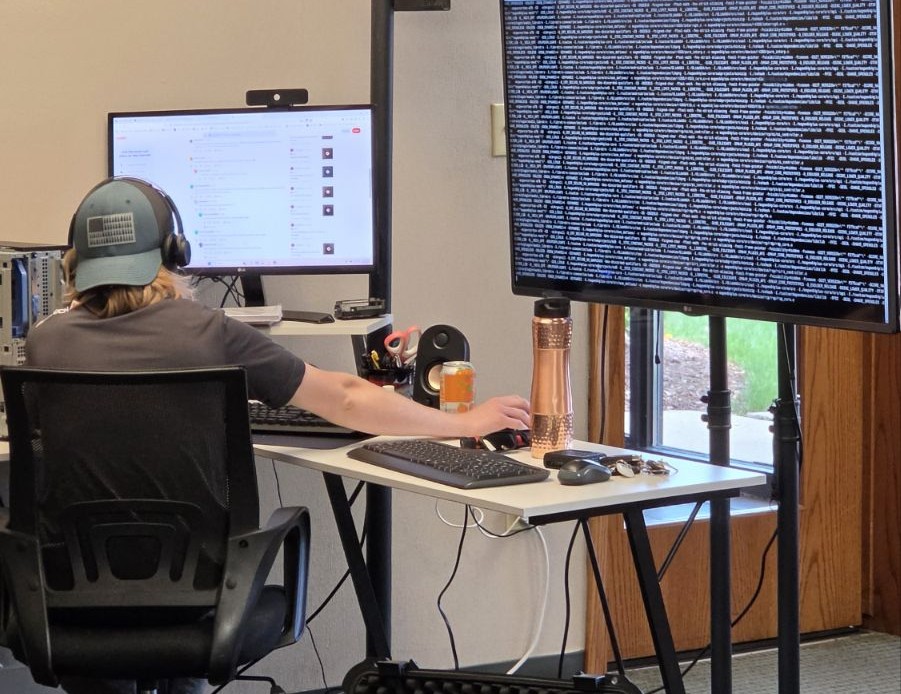 An AdvaTech team member on a headset at the remote support desk