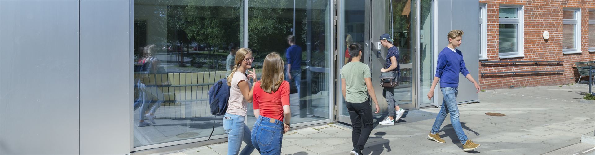 Students arriving at a school entrance.