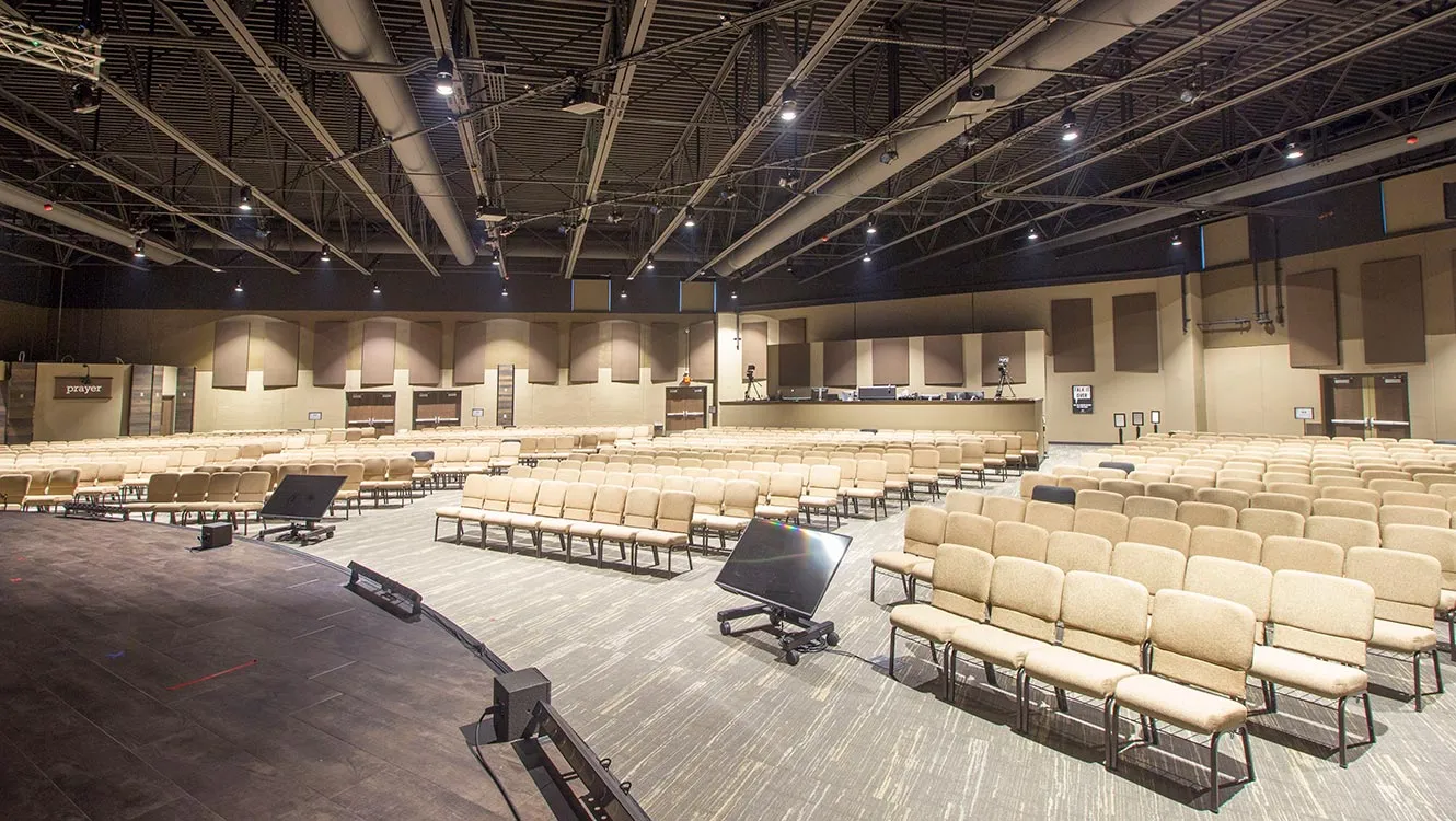Large auditorium with rows of seats facing a stage.